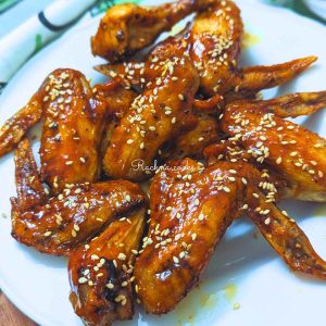 Delicious teriyaki chicken wings after air frying served on a white plate.