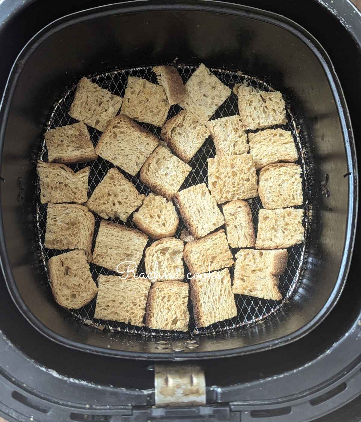 Bread cubes after air frying in air fryer basket