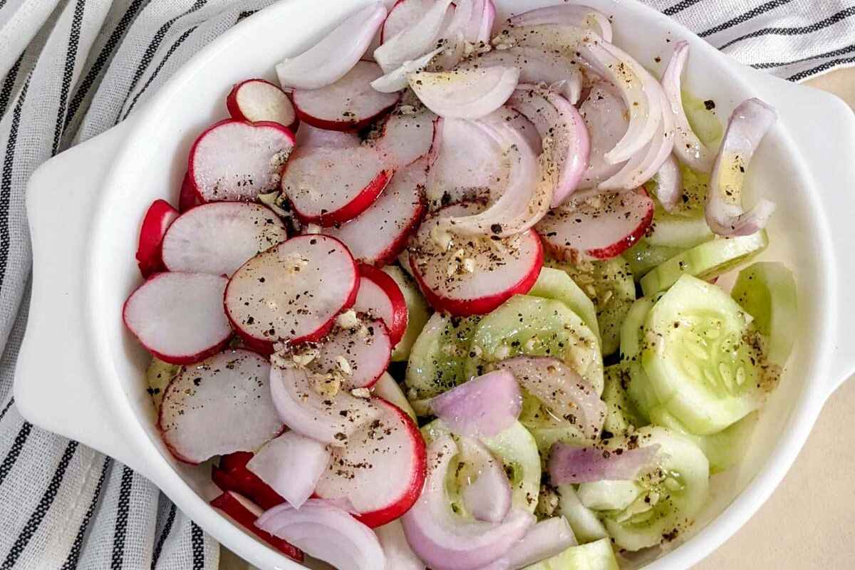 cucumber, radish and onion salad in a bowl
