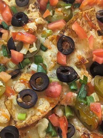 Close up of loaded nachos on a plate