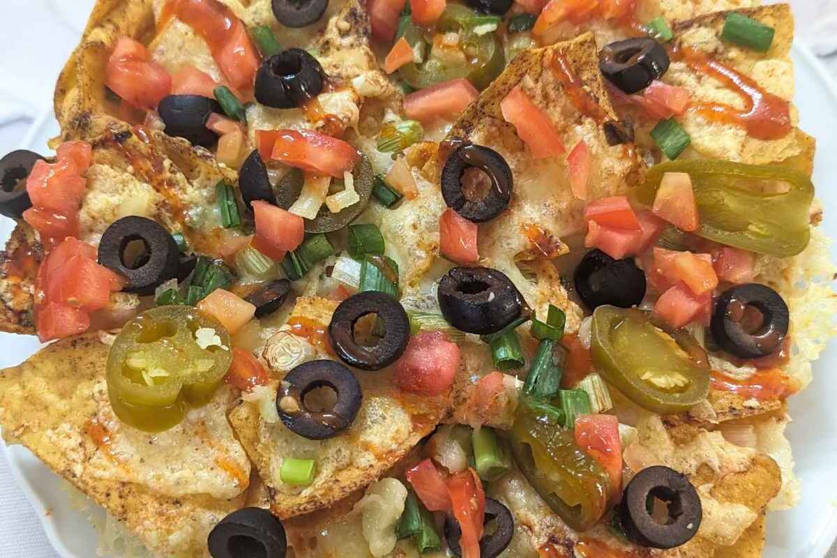 Close up of loaded nachos on a plate