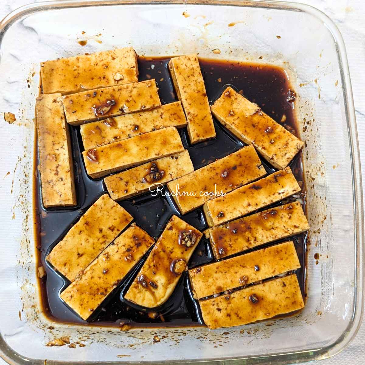Tofu fries with marinade in a glass bowl