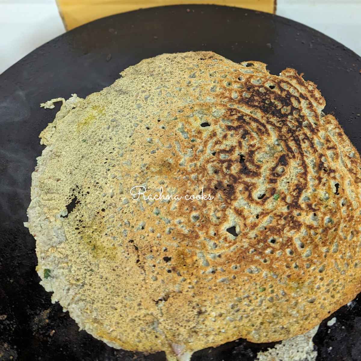 Golden brown vegan omelette on a tawa