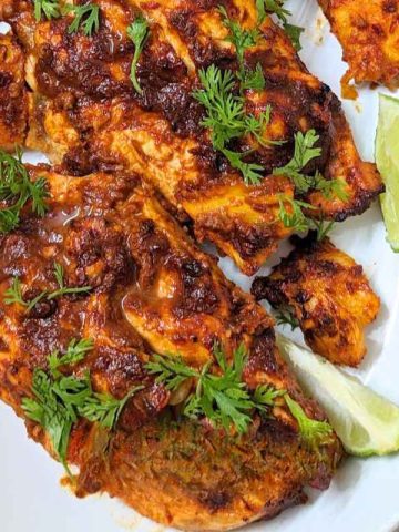 Chicken al pastor served on a white plate