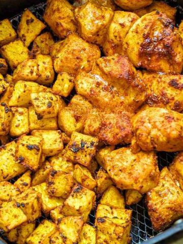 Close up of air fryer chicken and potatoes