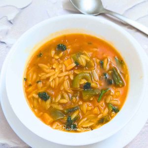 A bowl of orzo vegetable soup