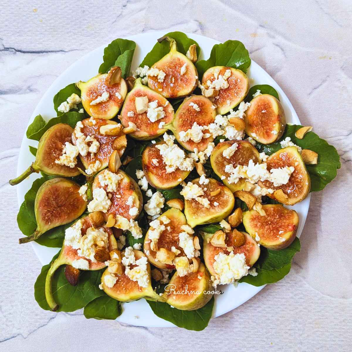 Fig and goat cheese with arugula salad on a plate