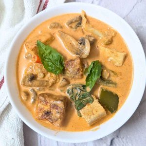 Thai red curry with crispy tofu served in a white bowl