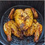 Whole chicken after air frying in air fryer basket