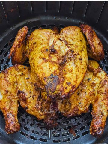 Whole chicken after air frying in air fryer basket