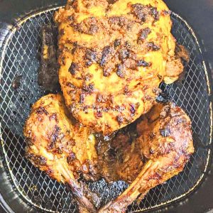 Air fryer whole tandoori chicken in air fryer basket