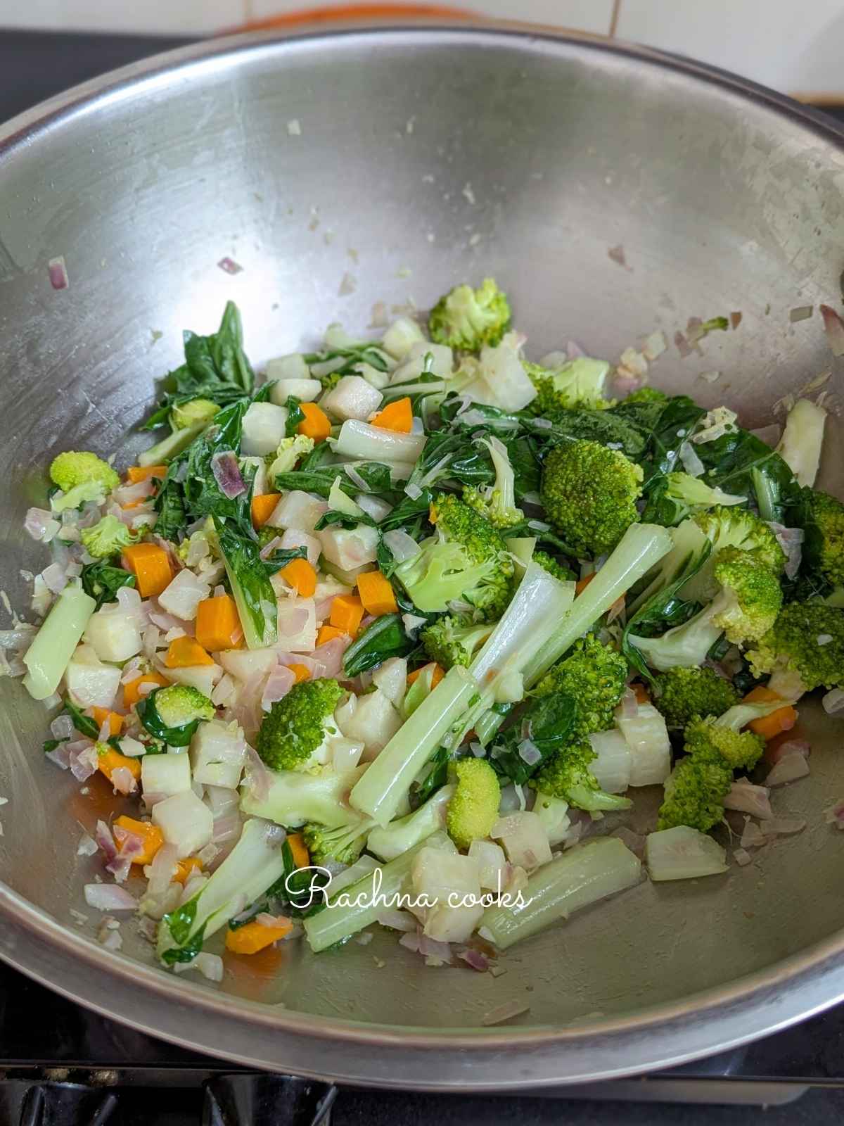 Veggies being stir fried in a pan