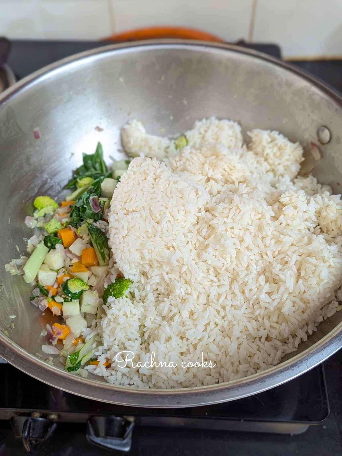 Rice in sauteed veggies in a pan