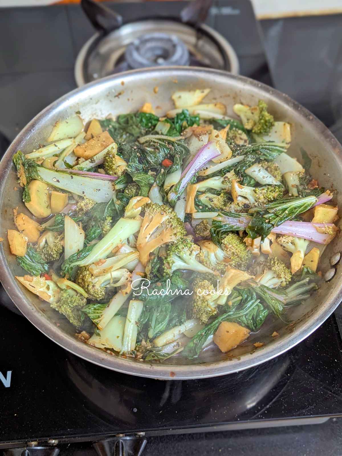 Veggies stir fried in sauce in a pan