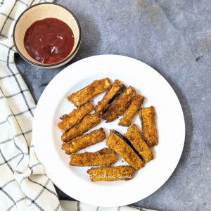 Eggplant fries on a plate served with ketchup