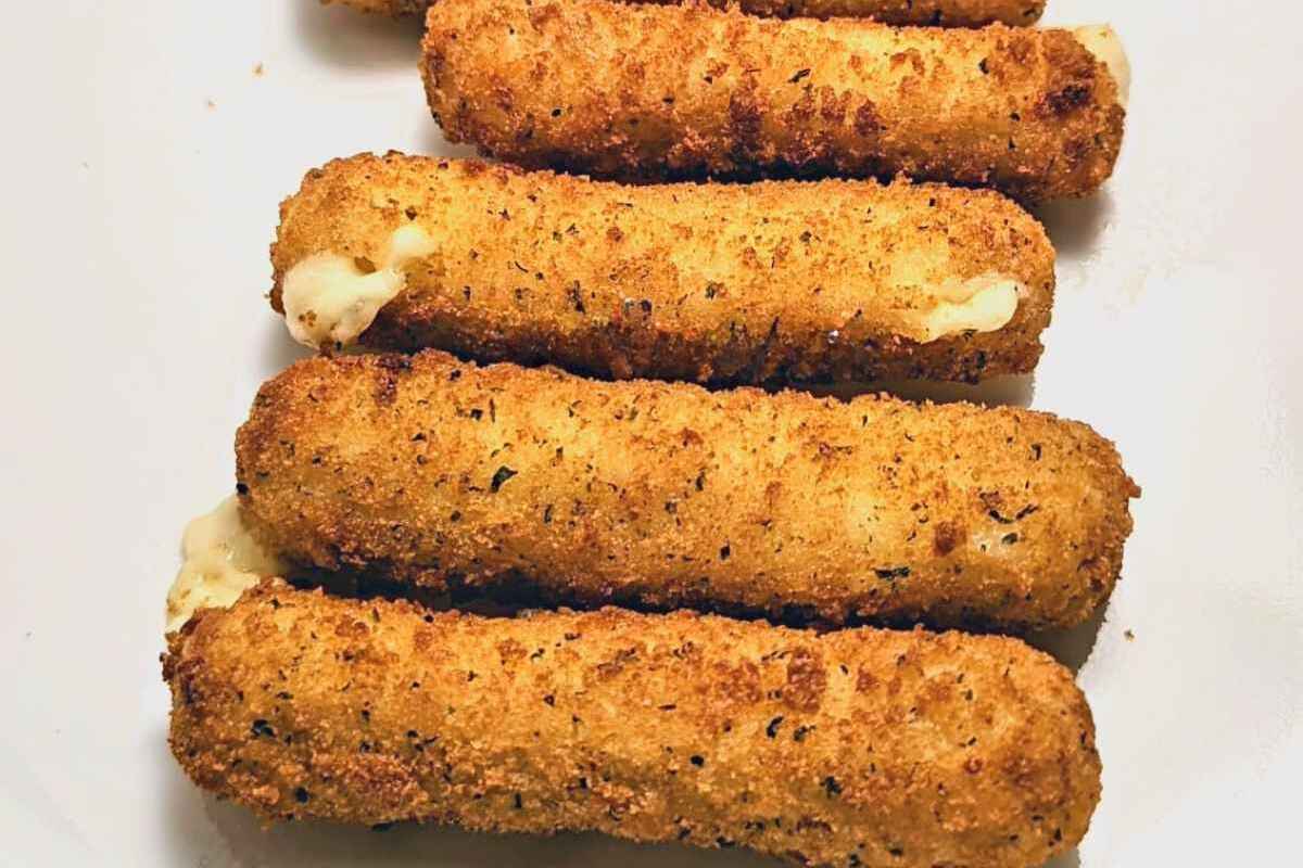 Cheesy mozzarella sticks on a plate