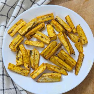 Plantain fries served on a white plate after air frying