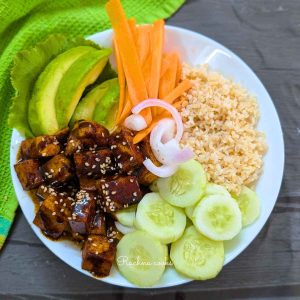 Tofu poke bowl with sauteed tofu, veggies and cooked rice.