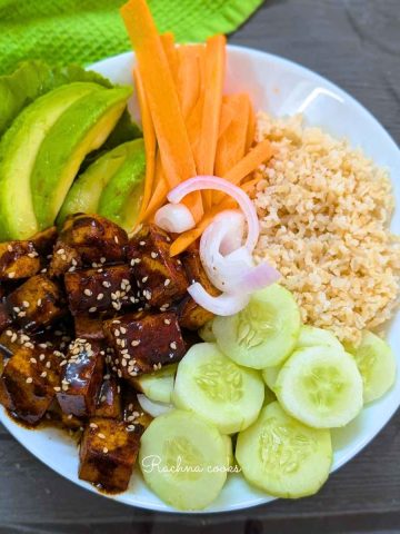 Tofu poke bowl with sauteed tofu, veggies and cooked rice.