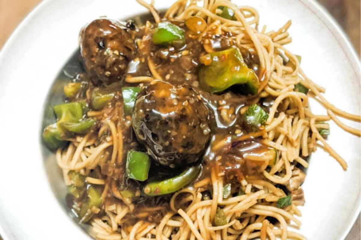 Veg manchurian on a plate with noodles.