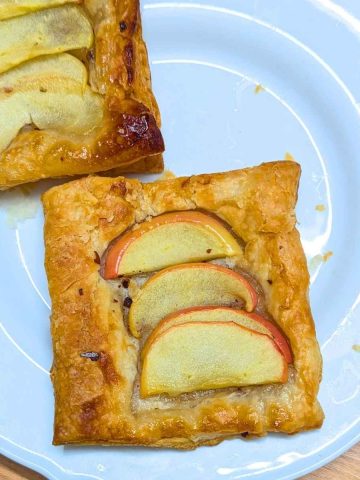 Two apple tarts on a white plate