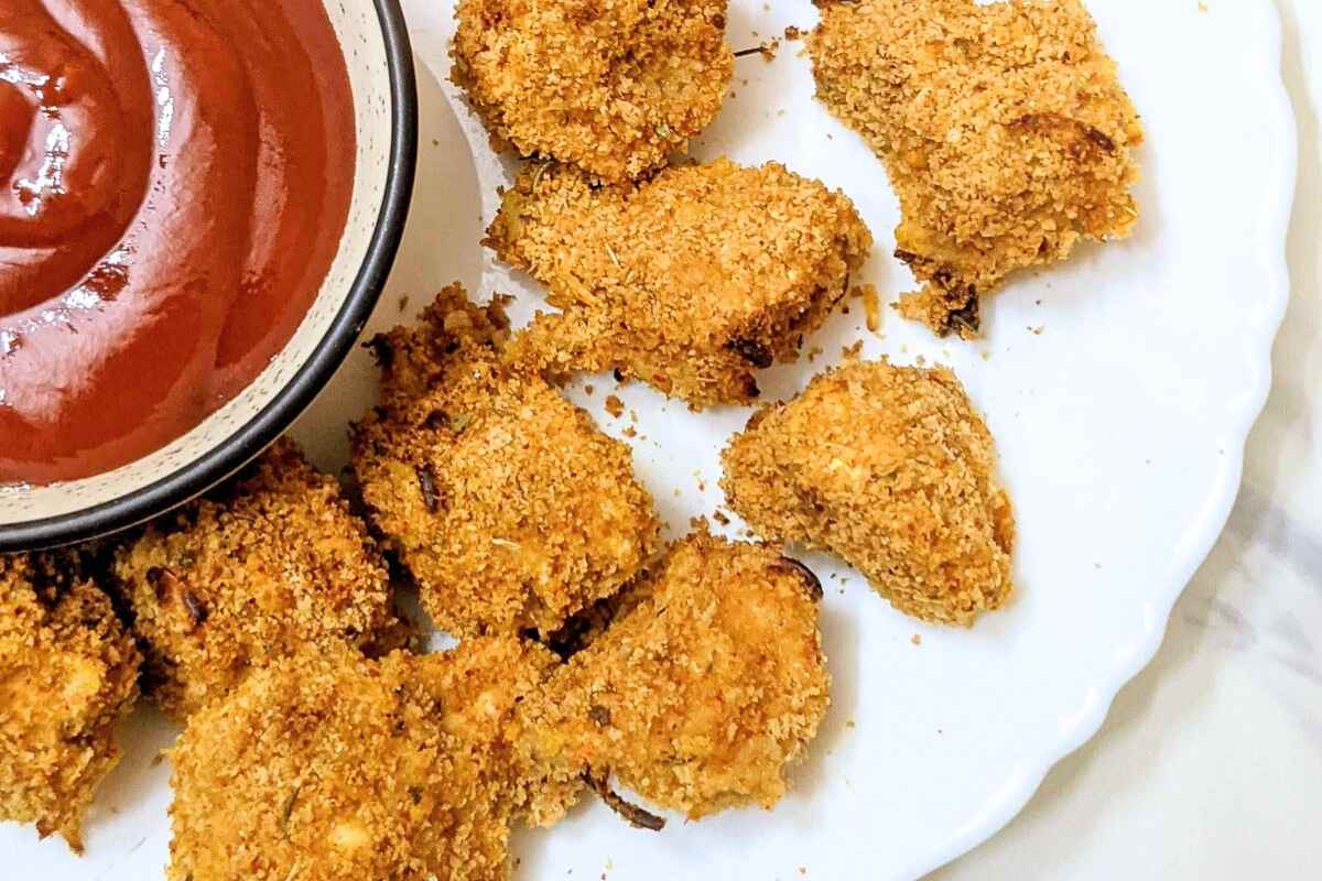 Breaded mushrooms after air frying on a plate.