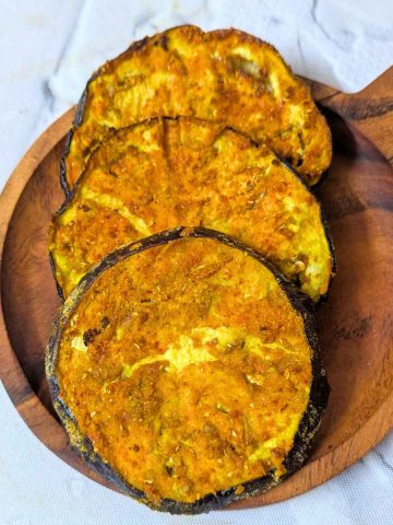 3 eggplant slices after air frying in a shallow plate