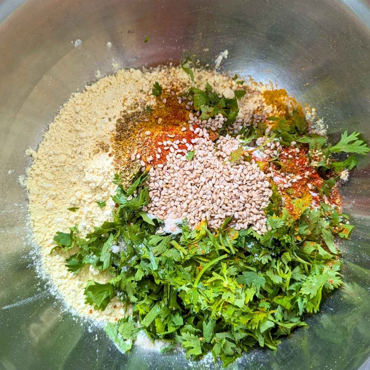 Chickpea flour mixed with cilantro leaves and spices.