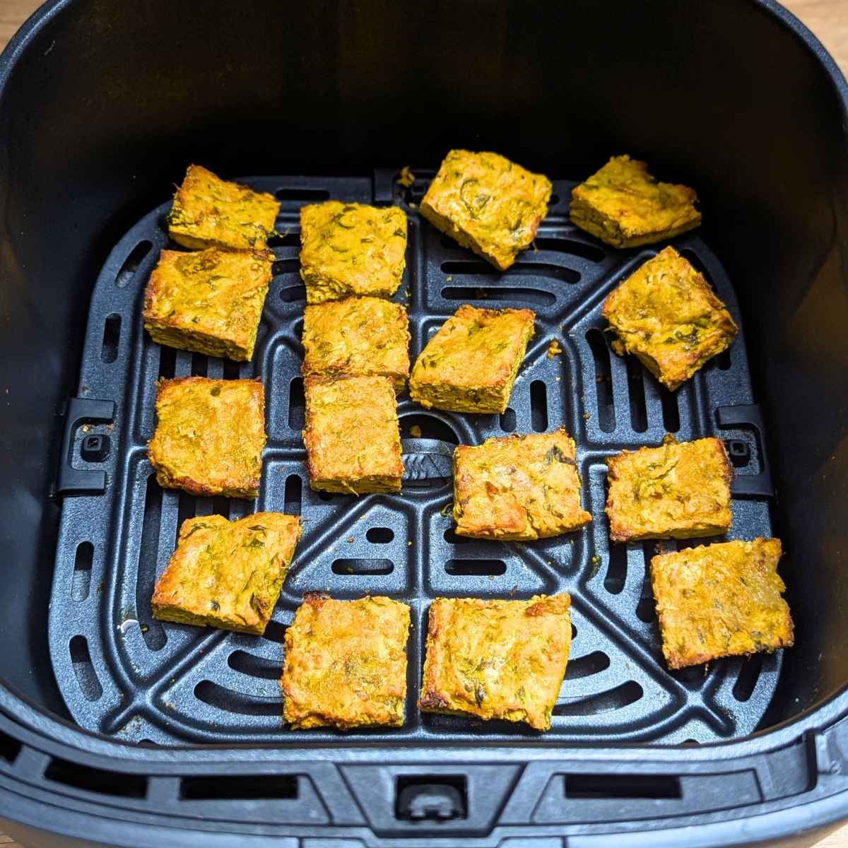 Crispy kothimbir vadi cubes after air frying.