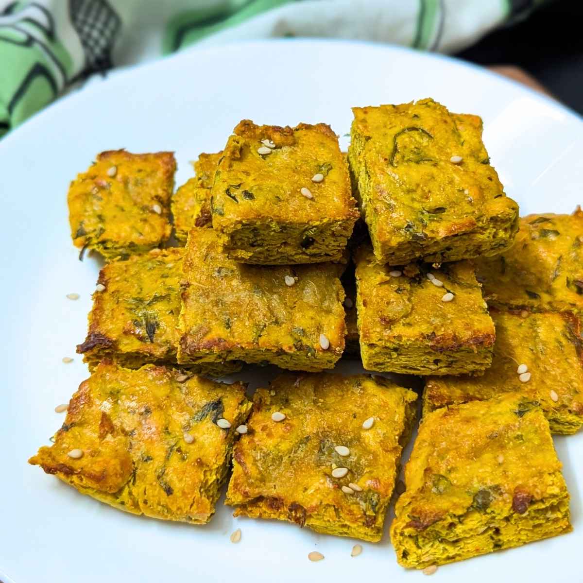 Kothimbir vadi served on a white plate.