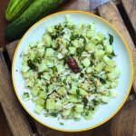 Indian cucumber salad served on a white plate.