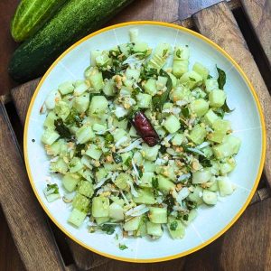 Indian cucumber salad served on a white plate.