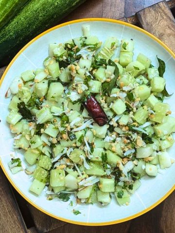 Indian cucumber salad served on a white plate.