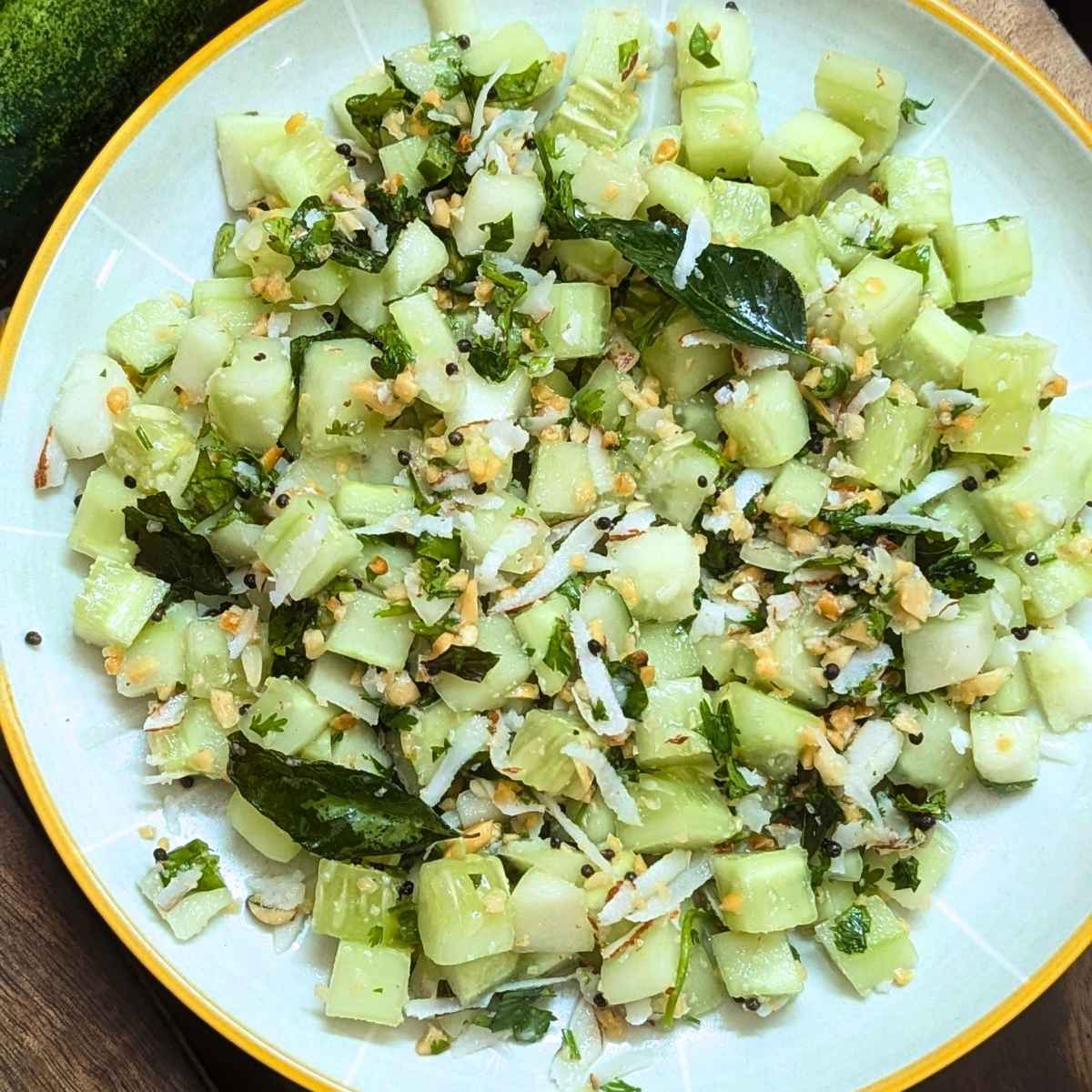 Indian cucumber salad served on a white plate.