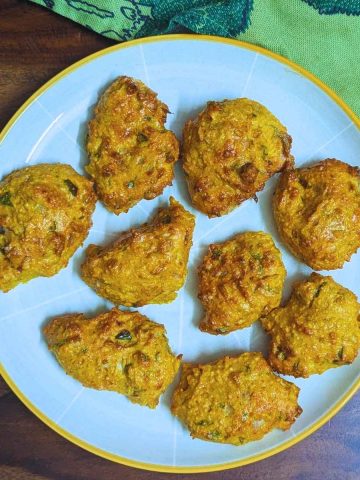 Moong dal pakora served on a white plate.
