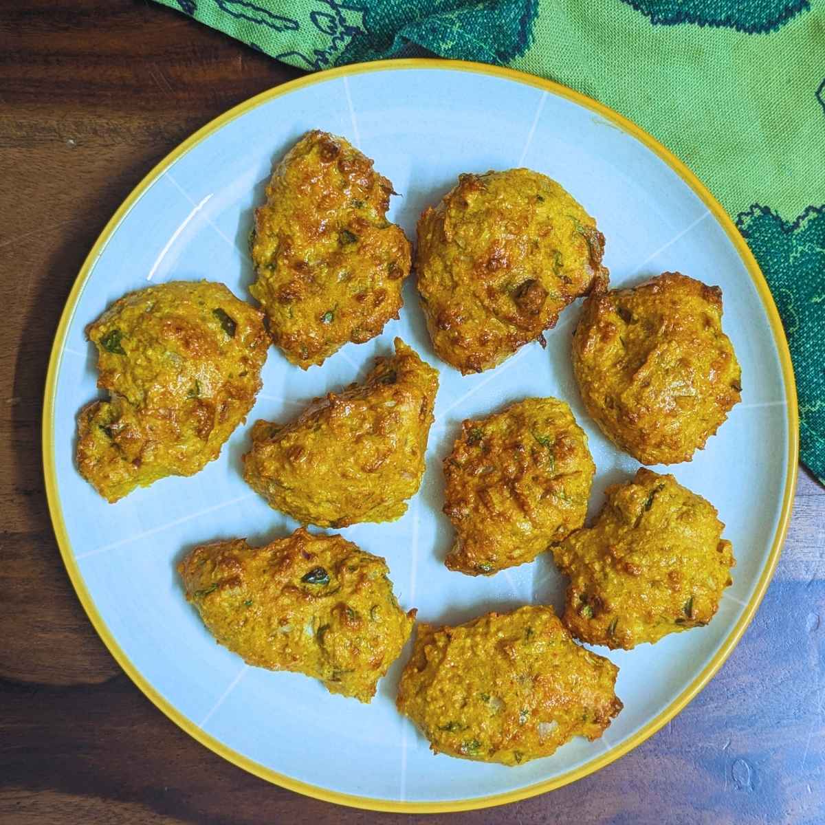 Moong dal pakora served on a white plate.