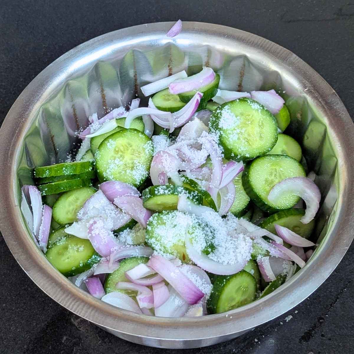Sliced cucumber and onion mixed with salt