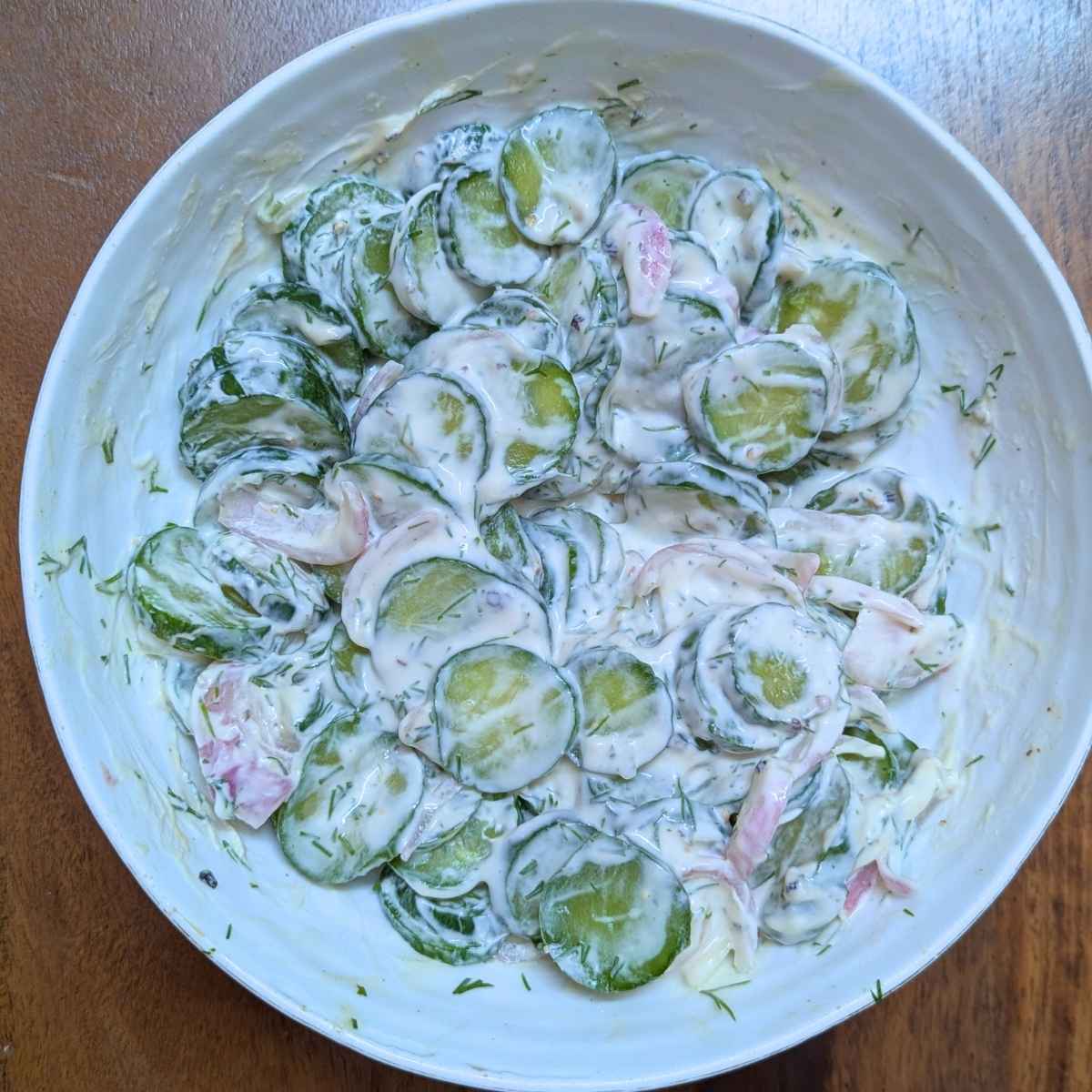 Creamy cucumber salad in a bowl