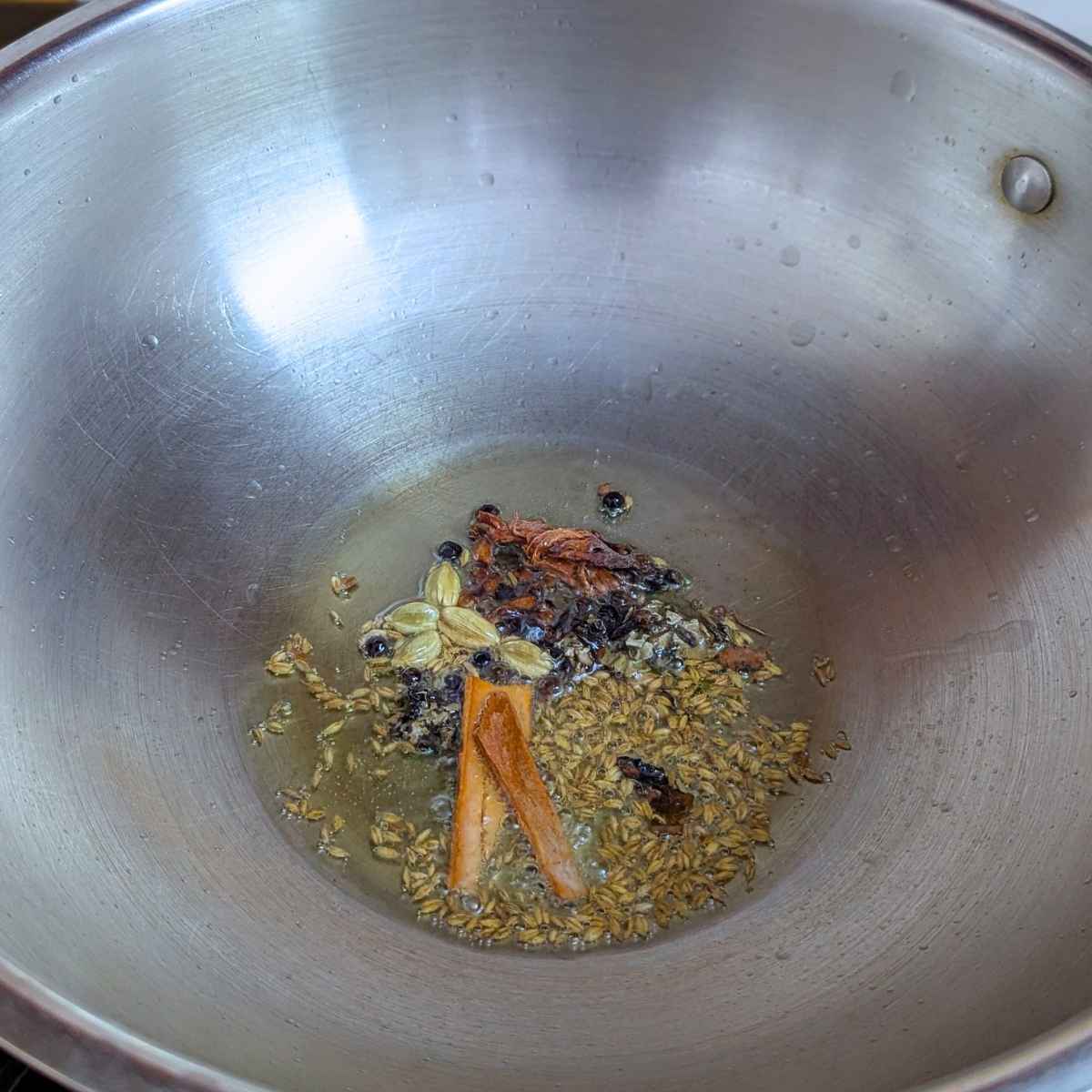 Whole spices in olive oil in a pan