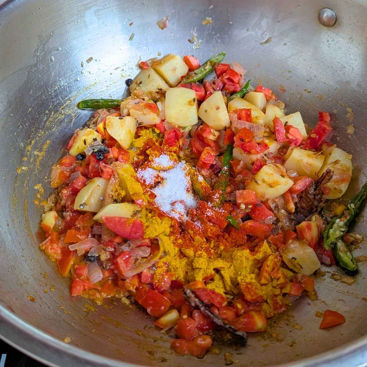 Turmeric, salt and biryani masala added to sauteed veggies