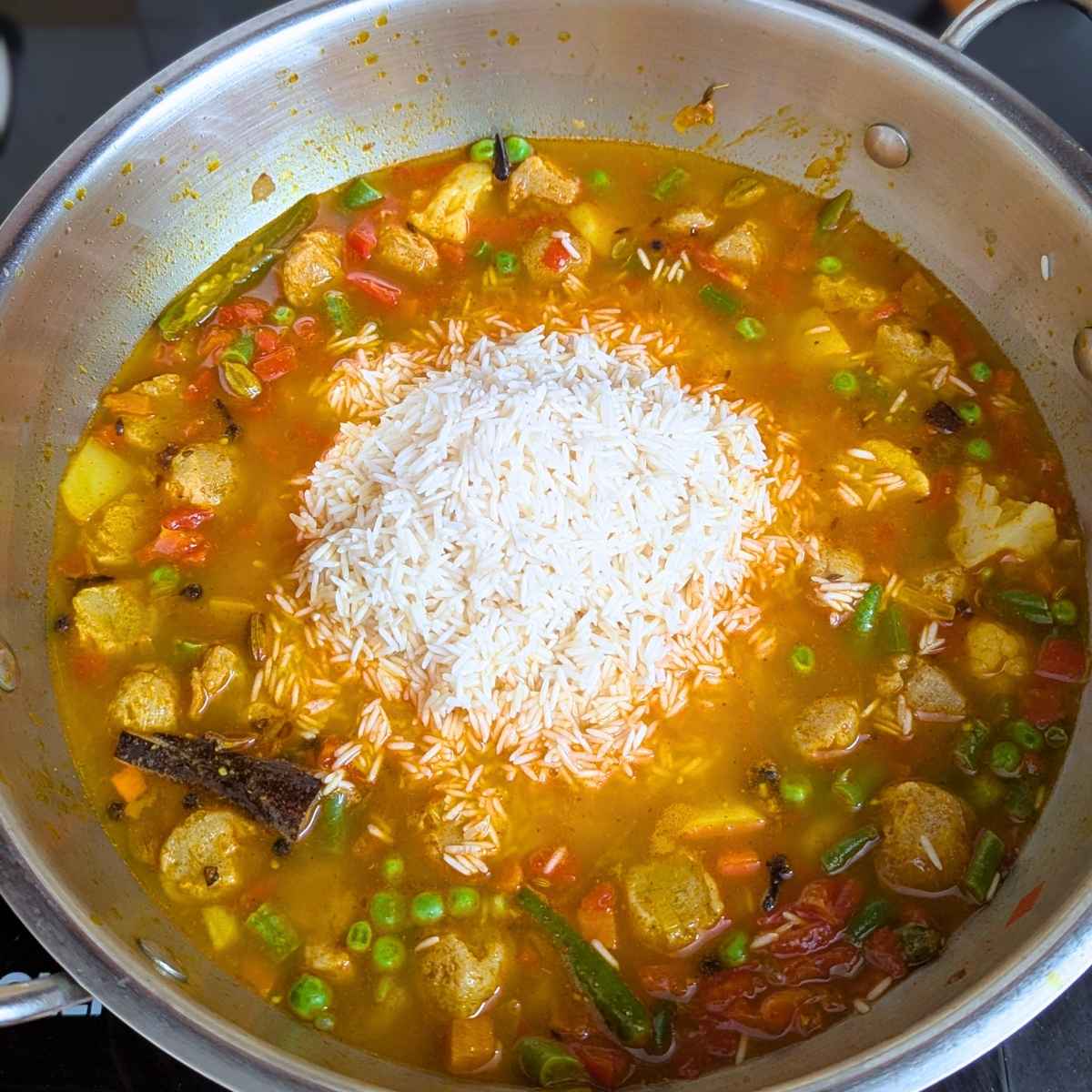 Basmati rice added to the pan