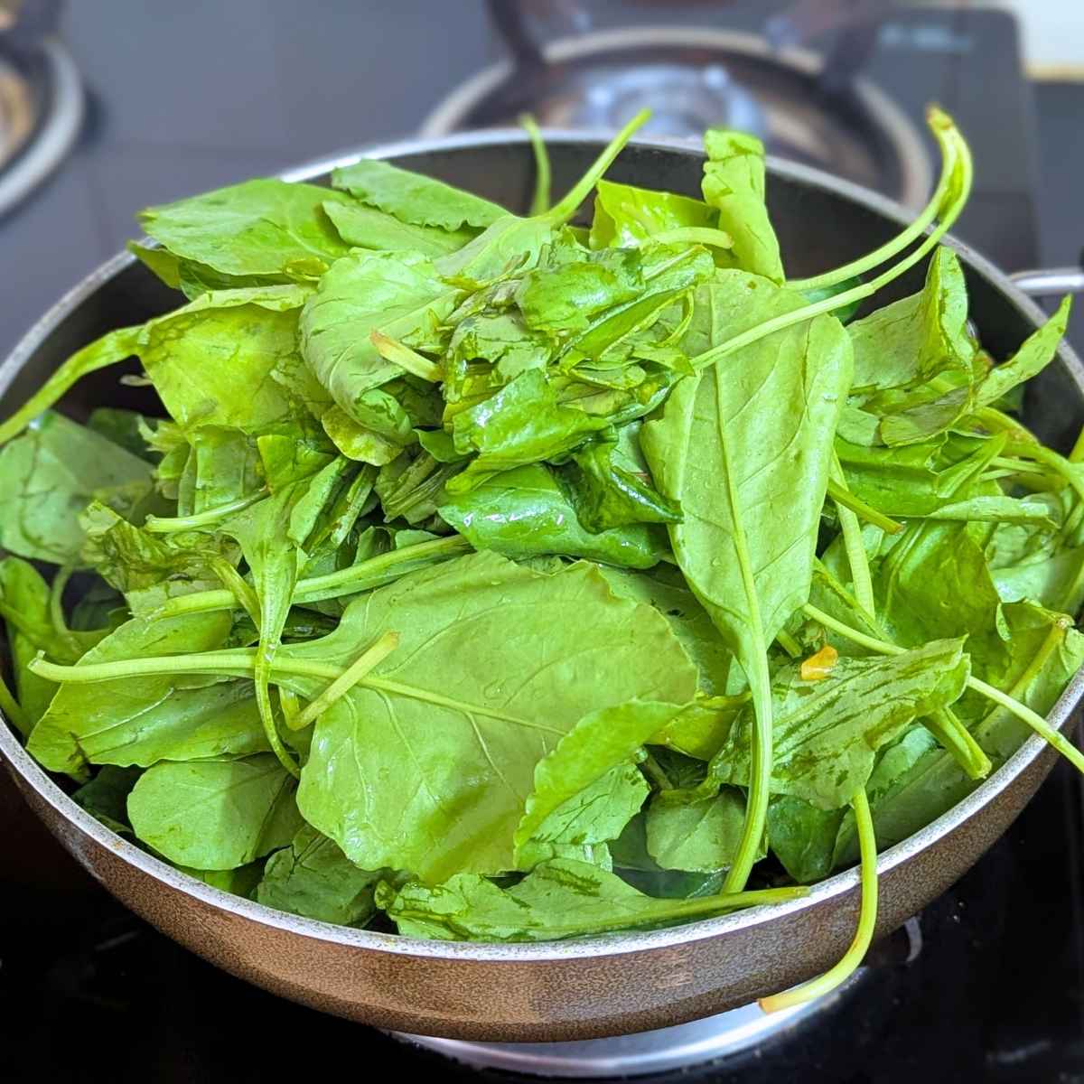 Washed spinach leaves in a pan.