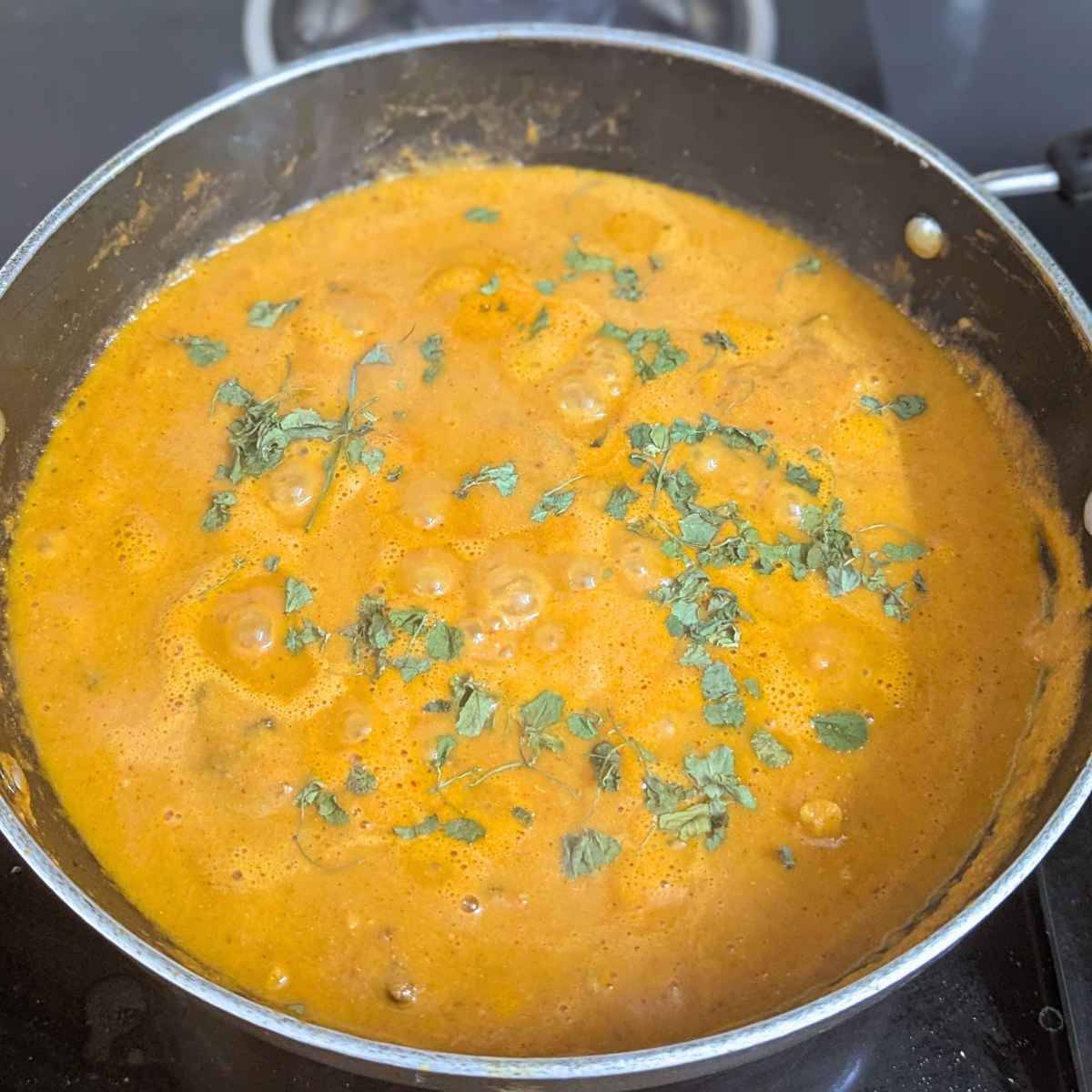 Chicken tikka masala curry in a pan.