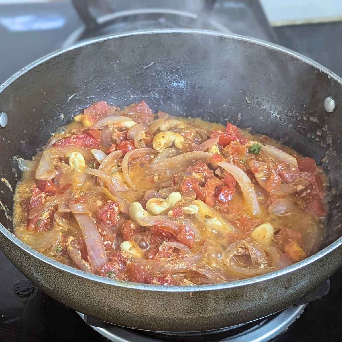 Onion, tomato, cashew and ginger garlic paste cooked down in a pan