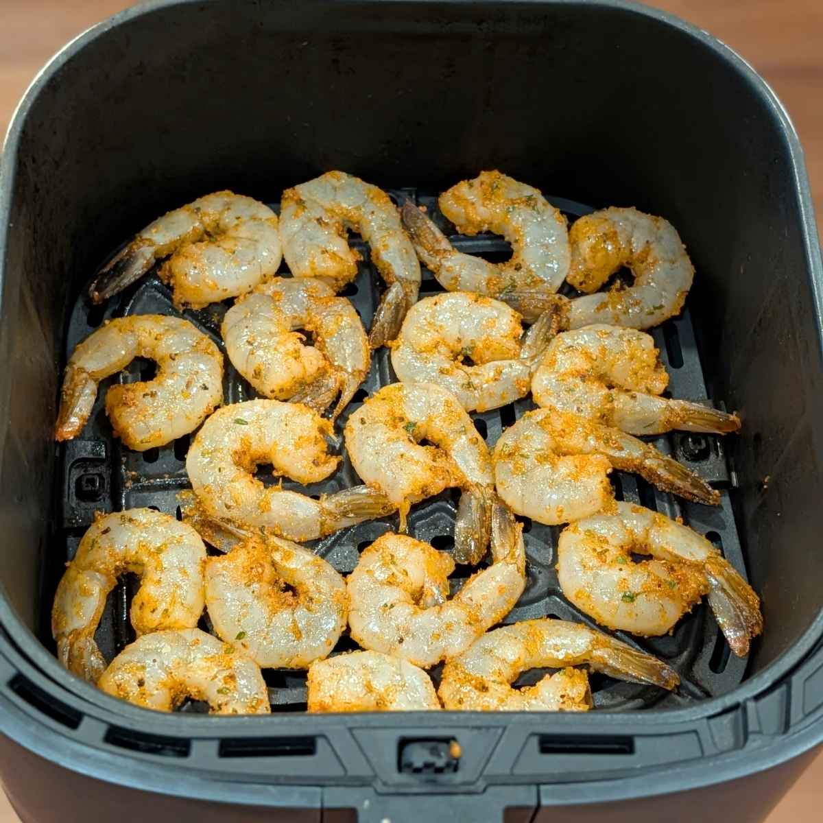 Seasoned shrimp in air fryer basket