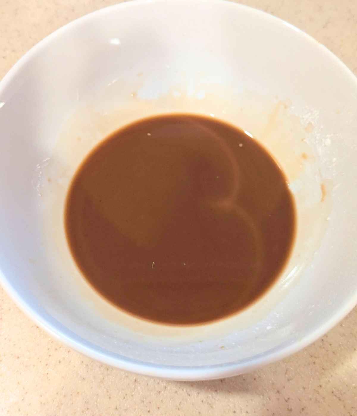 Teriyaki sauce in a white bowl