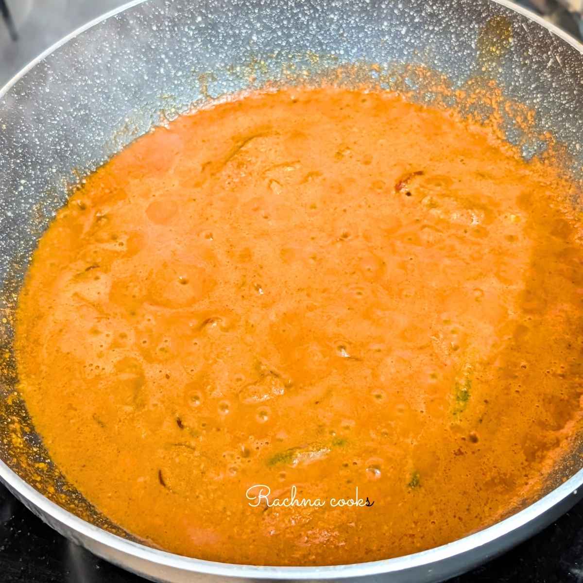 Thick curry paste being cooked in a pan