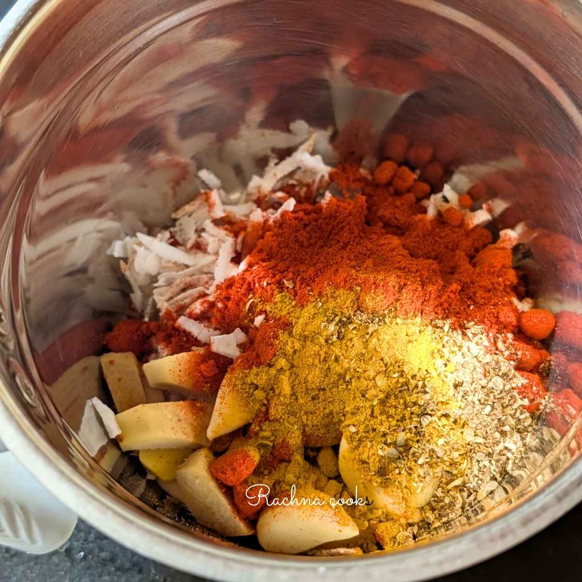 Grated coconut, ginger, garlic, chilli powder, salt, turmeric, and ground coriander in a blender to be blended