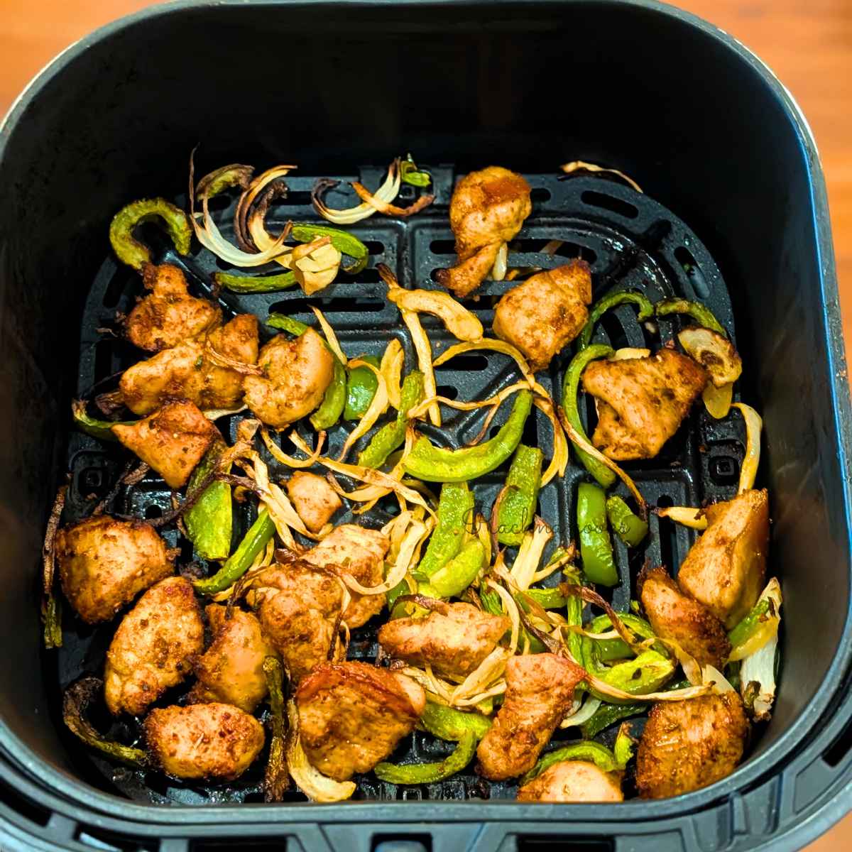 Chicken, peppers and onion in air fryer basket