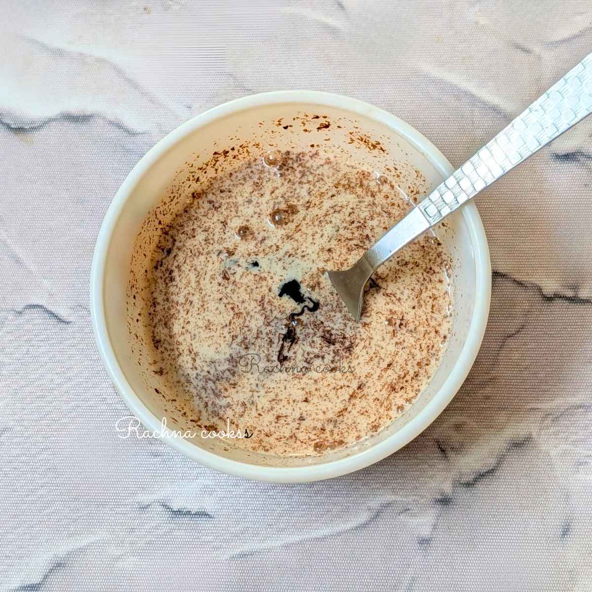 Milk, vanilla extract and honey added to melted dark chocolate